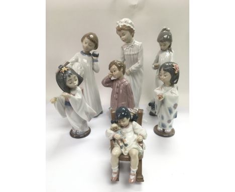 A collection of Lladro and Nao figures of children (7).