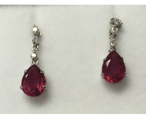 A pair of platinum ruby and diamond earrings with butterfly backs, boxed. Rubies 2.00ct. Diamonds 0.08ct