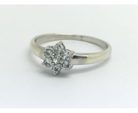 A 9ct white gold and seven aqua coloured stone cluster ring, approx 0.25ct, ring size approx N