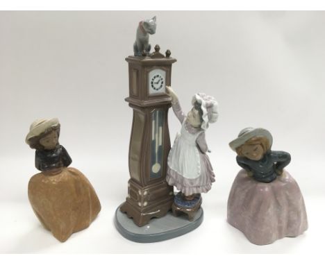 A Lladro figure of a girl and a longcase clock plus two Nao figures of girls (3).