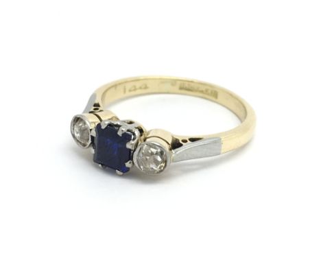 An 18ct yellow gold ring with central square sapphire and two old cut diamonds, ring size approx K/L