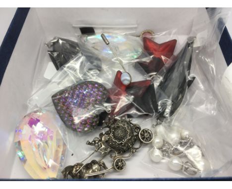 A box of sterling silver pendants, silver marcasite watch brooch and two silver stick pins.