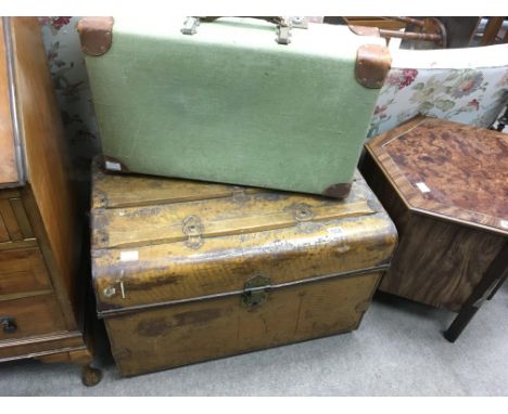 A large vintage painted shipping chest, plus a green canvas and leather mounted suitcase.