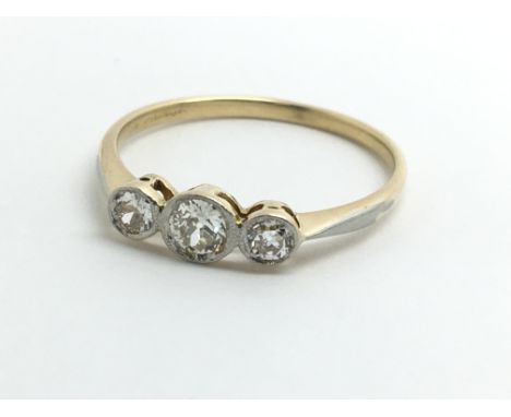 An 18ct yellow gold ring set with three diamonds, approx 0.25ct, size approx O