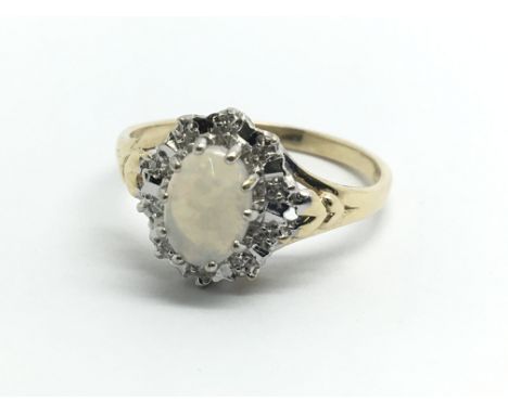 A 9ct yellow gold opal and diamond cluster ring, approx size K/L