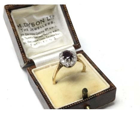 An 18ct central ruby surrounded by diamonds, R.
