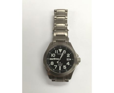 A Citizen eco pro master titanium watch with black face and date aperture.