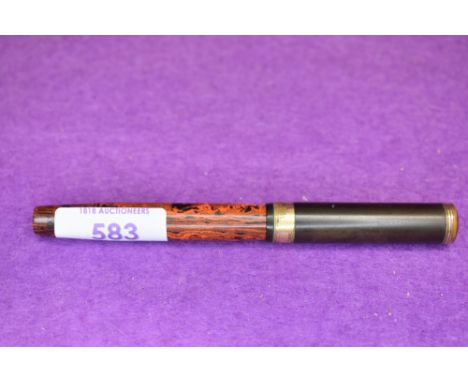 A Mabie Todd Swam leverfill fountain pen with an orange and black patern, the cap top has the same colour as the barrel but l