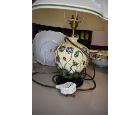 A Moorcroft Hepatica table lamp having cream and blue ground with lilac flowers.
No visible faults or repairs