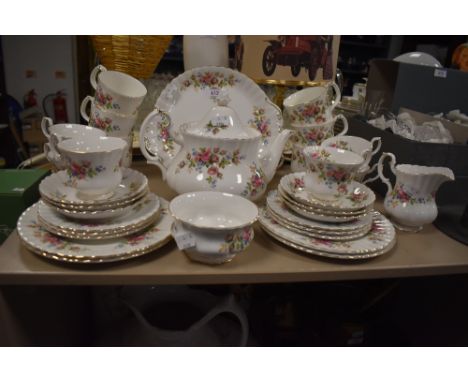 A part tea service, Moss Rose by Royal Albert, including cake plate, tea pot cups and saucers and more, around thirty two ite