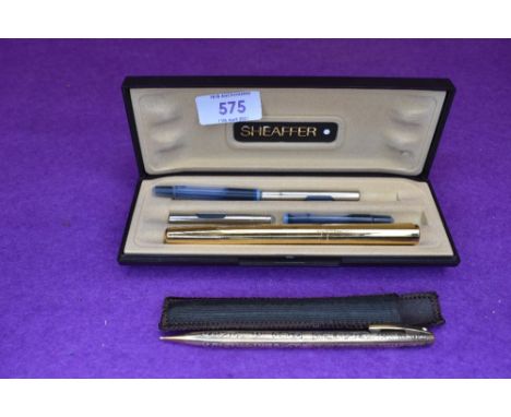 A Waterman gold coloured cartridge fountain pen with facetted barrel and a Sheafer Golden Vintage 12k gold filled mechanical 