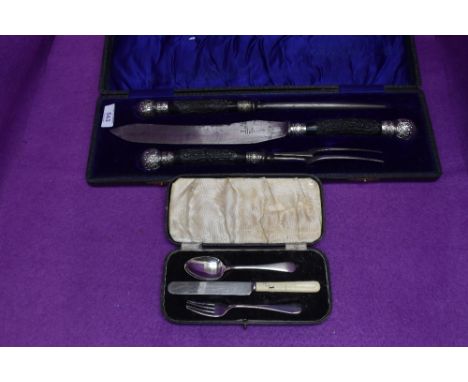 A cased three piece carving set having black antler handles with white metal finials, James Deakin, and a child's cased three