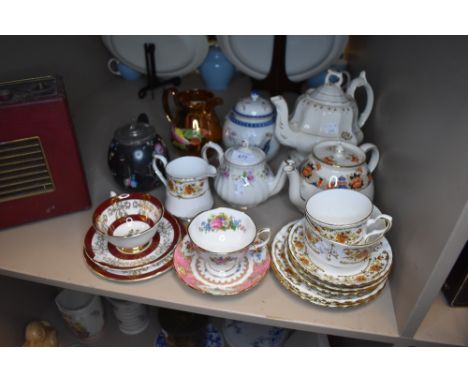 A selection of teapots and teacups including Delhi and Royal Albert
MINOR HAIRLINE TO INNER LIP OF TEAPOT. POSSIBLE HINGE TO 