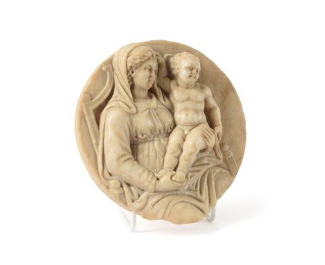A NORTH ITALIAN SCULPTED WHITE MARBLE TONDO OF THE VIRGIN AND CHILD ENTHRONEDLATER 16TH CENTURYThe Christ Child portrayed sea