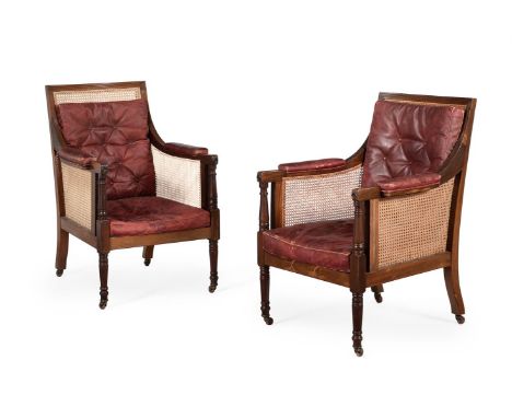 A PAIR OF MAHOGANY LIBRARY BERGERE ARMCHAIRSIN REGENCY STYLE, EARLY 20TH CENTURY each 104cm high, 70cm wide, 75cm deep overal