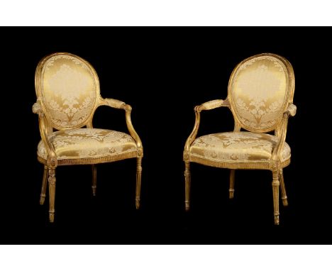 A PAIR OF GEORGE III GILTWOOD AND YELLOW DAMASK UPHOLSTERED OPEN ARMCHAIRS IN THE FRENCH TASTE, CIRCA 1780 each 93cm highProv