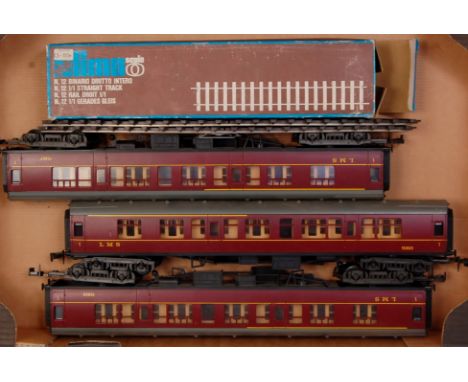 A large tray containing 3x Lima plastic 1st class maroon LMS bogie coaches No. 15865 (G) with a box containing 10x Lima strai