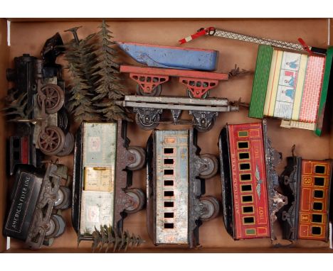 A small tray containing a cast iron American Flyer 0-4-0 clockwork loco with fixed key 4-wheel tender and 3x coaches, one mis