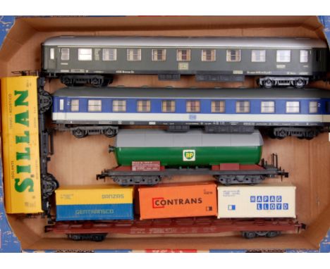 A large tray containing Rivarossi green bogie DB 1st Class coach, Rivarossi blue DB 2nd class coach, Lima bogie BP tanker, Li