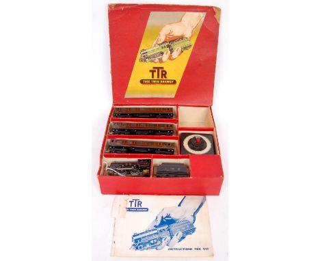 Trix Twin Railway train pack containing LMS black engine and tender No. 5049 and 3 LMS short coaches all with pre-war couplin