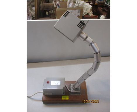A 1970's engineering adjustable desk lamp converted and mounted on a wooden baseLocation: FSR 