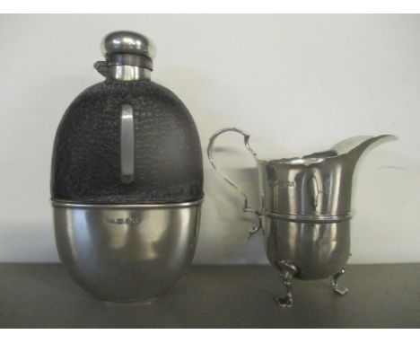 A silver and glass hip flask and a silver cream jug, 77gLocation: 