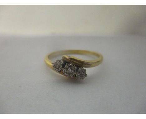 An 18ct gold and platinum ring inset with three illusion set diamondsLocation: 