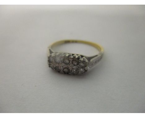 An 18ct gold and platinum ring inset with ten diamonds, 2.2gLocation: 