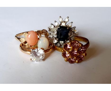 Four dress rings to include a 14ct carat gold contemporary ring with an opal and a coral stone, total weight 12g.Location: RI