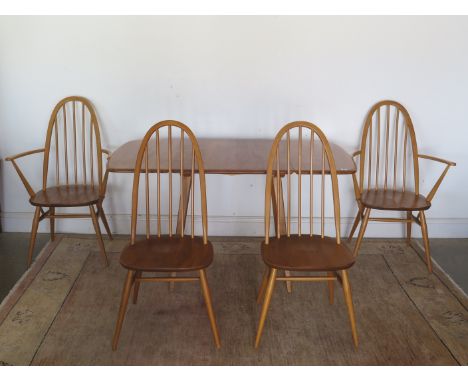 A circa 1960s Ercol elm drop-flap extending dining table and four chairs, two carvers and two diners, in good condition, some