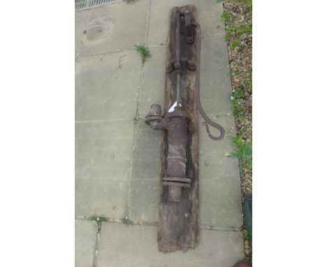 A vintage hand operated water pump on a wooden mount - 167cm tall 