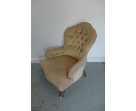 A Victorian button back fireside chair 