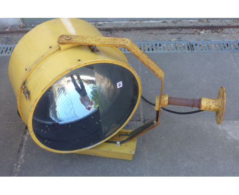 A very large Harley Aircraft Landing Light type FM- serial no 9991- yellow painted aluminium raising on iron gimble and stand