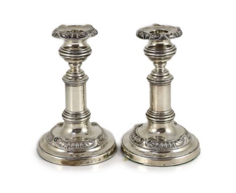 A pair of George III silver telescopic candlesticks, by S.C. Younge &amp; Co,with gadrooned and scroll decoration, on circula