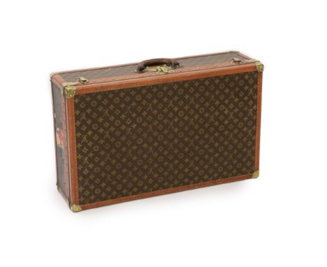 A Louis Vuitton brass mounted leather bound suitcase,number 77612,76 x 46cm depth 22cmOverall looks to be in fair to good ord