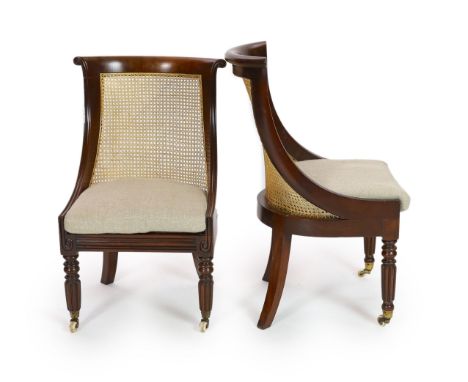 A pair of late Regency mahogany bergere side chairs,with overscrolled top rails to the cane filled 'Grecian' backs, loose squ
