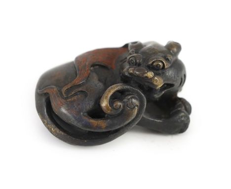 A Chinese bronze ‘lion dog’ scroll weight, Ming or later,6.4cm longOccasional minor dents and wear to the patina. Otherwise i