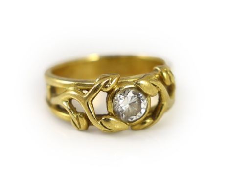 A modern pierced 18ct gold and solitaire diamond set band,the setting modelled as scrolling leaves, the stone approx. 0.45ct,