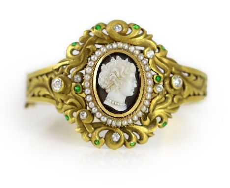 A Victorian gold, sardonyx cameo, split pearl, diamond and demantoid garnet set hinged bangle,with pierced oval scroll settin