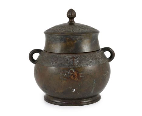 A Chinese Ming bronze jar and cover, hu,of oval section, cast in low relief with bands of stylised creatures on a leiwen grou
