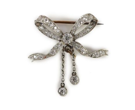 A Victorian gold, silver and diamond cluster set ribbon bow brooch, with two diamond set graduated drops,with safety chain, w