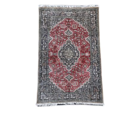 An early 20th century Caucasian silk red ground rug,with central stepped lozenge central medallion, Field woven with stylised