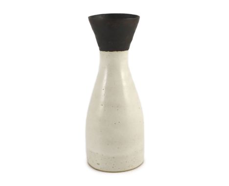 § § Dame Lucie Rie (1902-1995), a stoneware conical vase,covered in a cream glaze, the flared neck with manganese glaze, impr