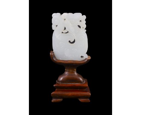 A Chinese white jade plaque, 19th century,carved as an archaistic mythical beast,4.9cm, splinter chip, wood stand,Natural inc