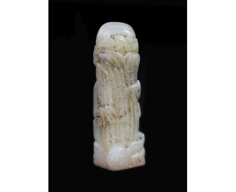 A small Chinese white and grey jade seal,carved in the form of shafts of bamboo beside a pillar of rock, engraved matrix,3.7c