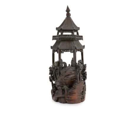 A Chinese bamboo model of a pavilion, 19th century,intricately carved with a scene of dignitaries and other figures inside an