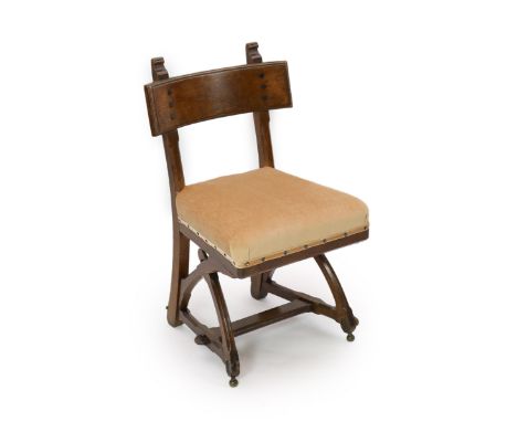 A Victorian reformed gothic oak dining chair designed by Edward Welby Pugin, c.1864,with revealed pegs to the mortice and ten