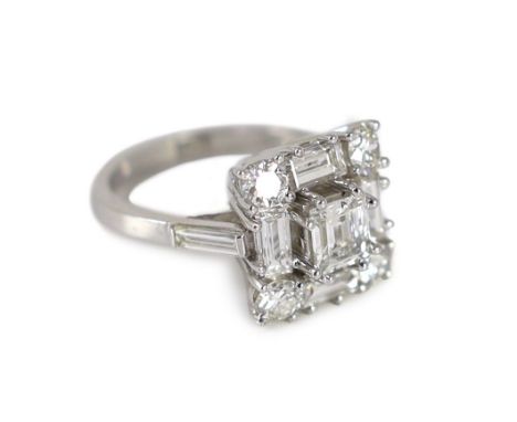 A square, baguette and round cut diamond set square cluster ring,the stones of good colour, clarity range VS-SI2, with baguet