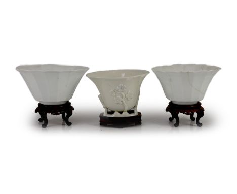 A pair of Chinese blanc-de-chine fluted bowls and a similar libation cup, Dehua kilns, 17th century,6.5cm high &amp; 7.5cm wo