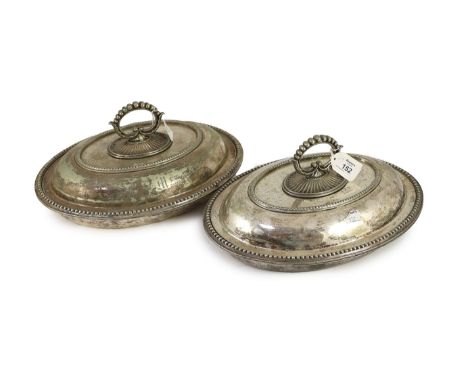 A pair of plated oval entree dishes, covers and detachable handles,with beaded borders, each initialled 'M' and numbered 1,2 